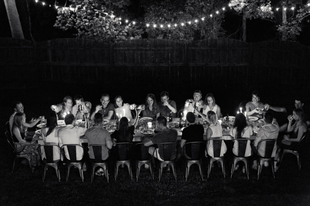 Nightime party with signature farm table