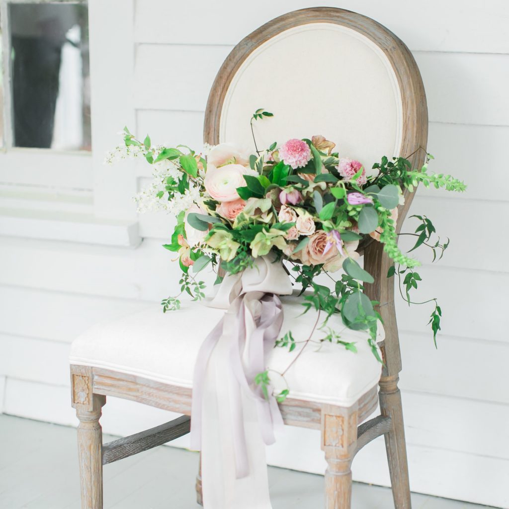 Raleigh Upholstered Chair with floral arrangement